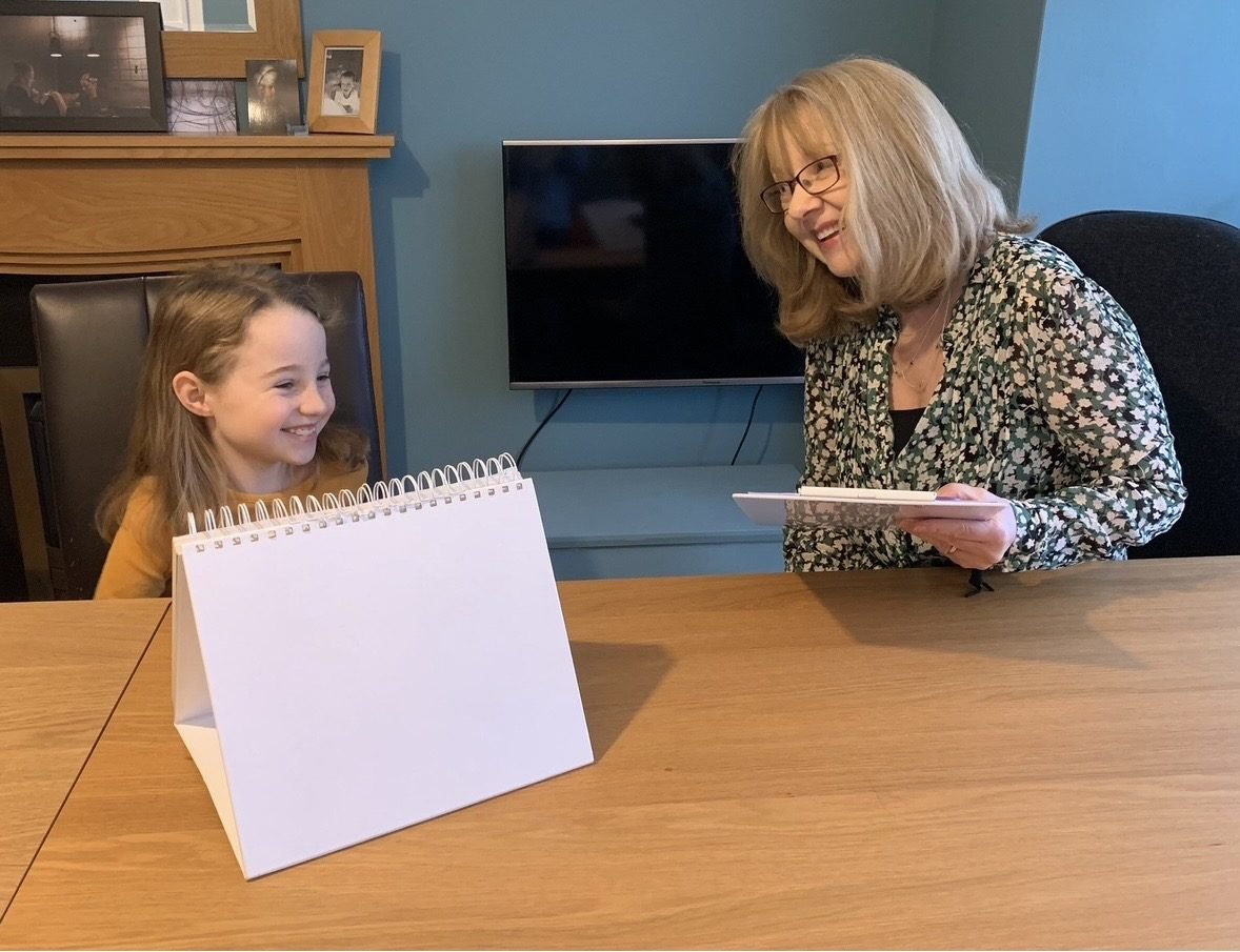 Christine working with a young child at the table